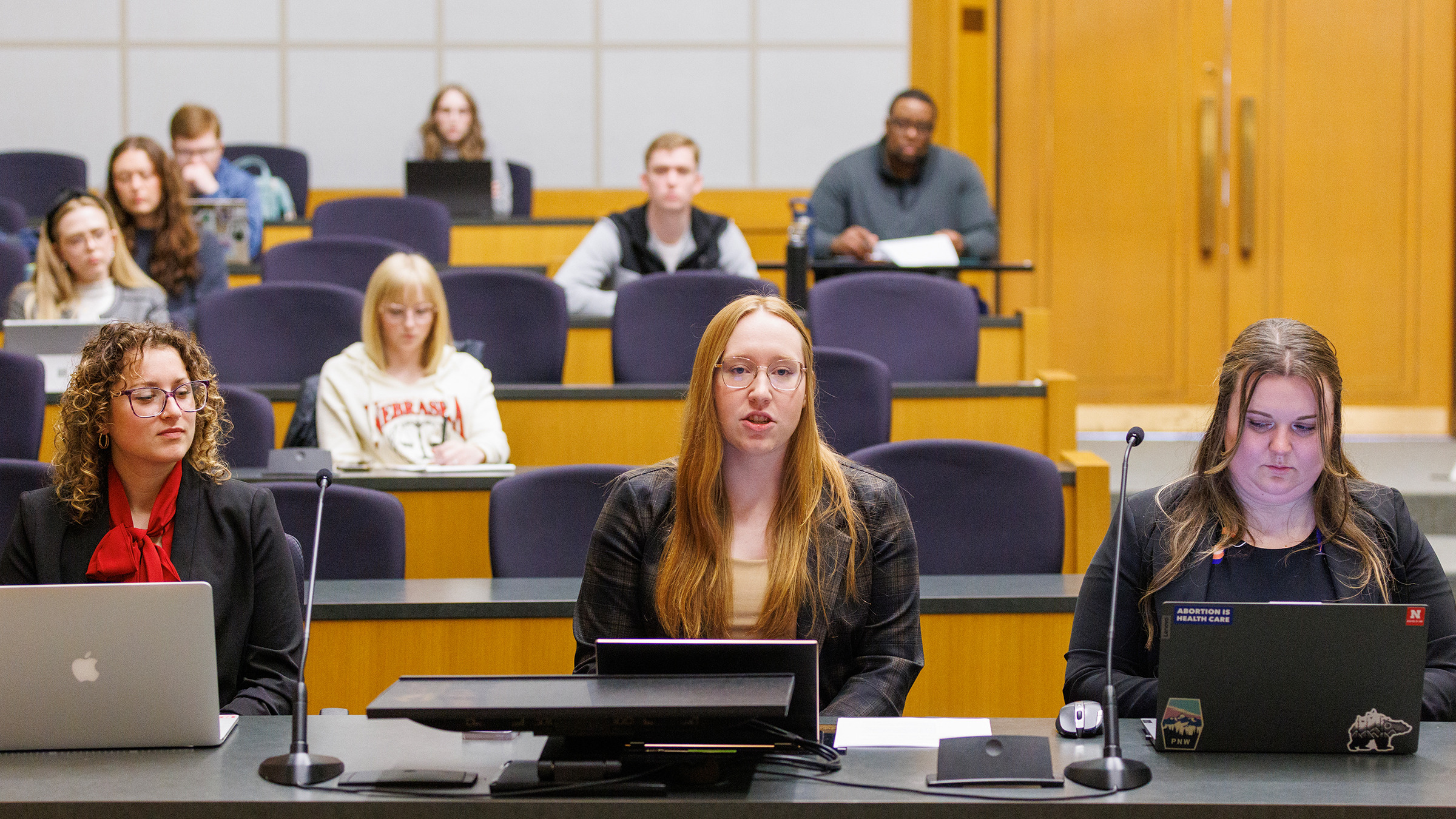 Students sitting in a lecture hall style class