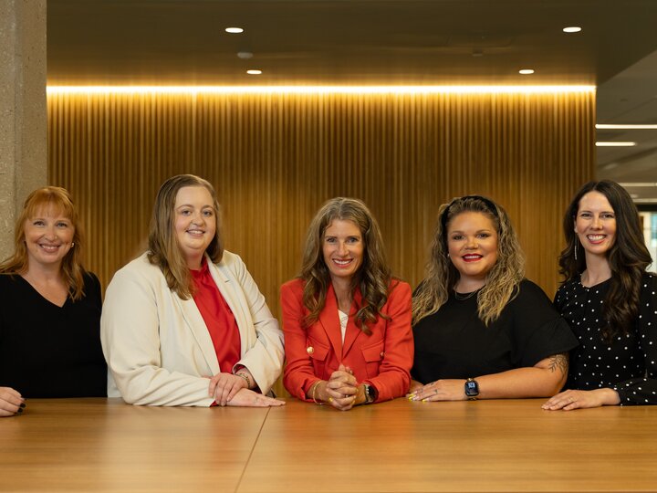 Center Leadership Team leaning on a table